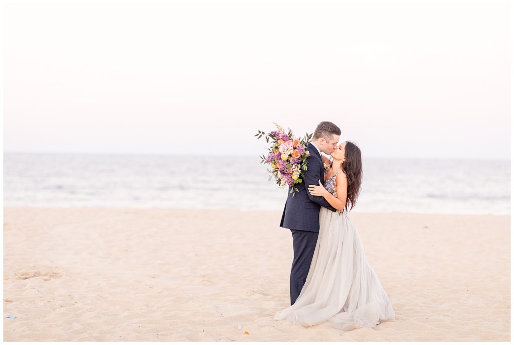 Husband and wife kiss during New Jersey Beach Elopement Session photographed by Diana and Korey Photo and Film.