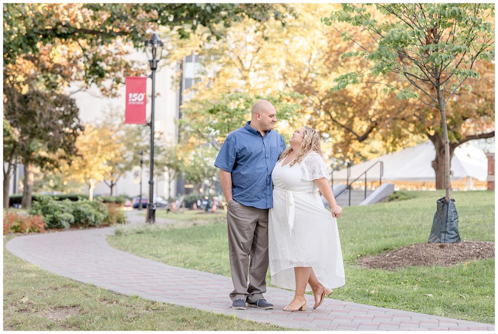Happy couple walks through Hoboken NJ for their engagement photos