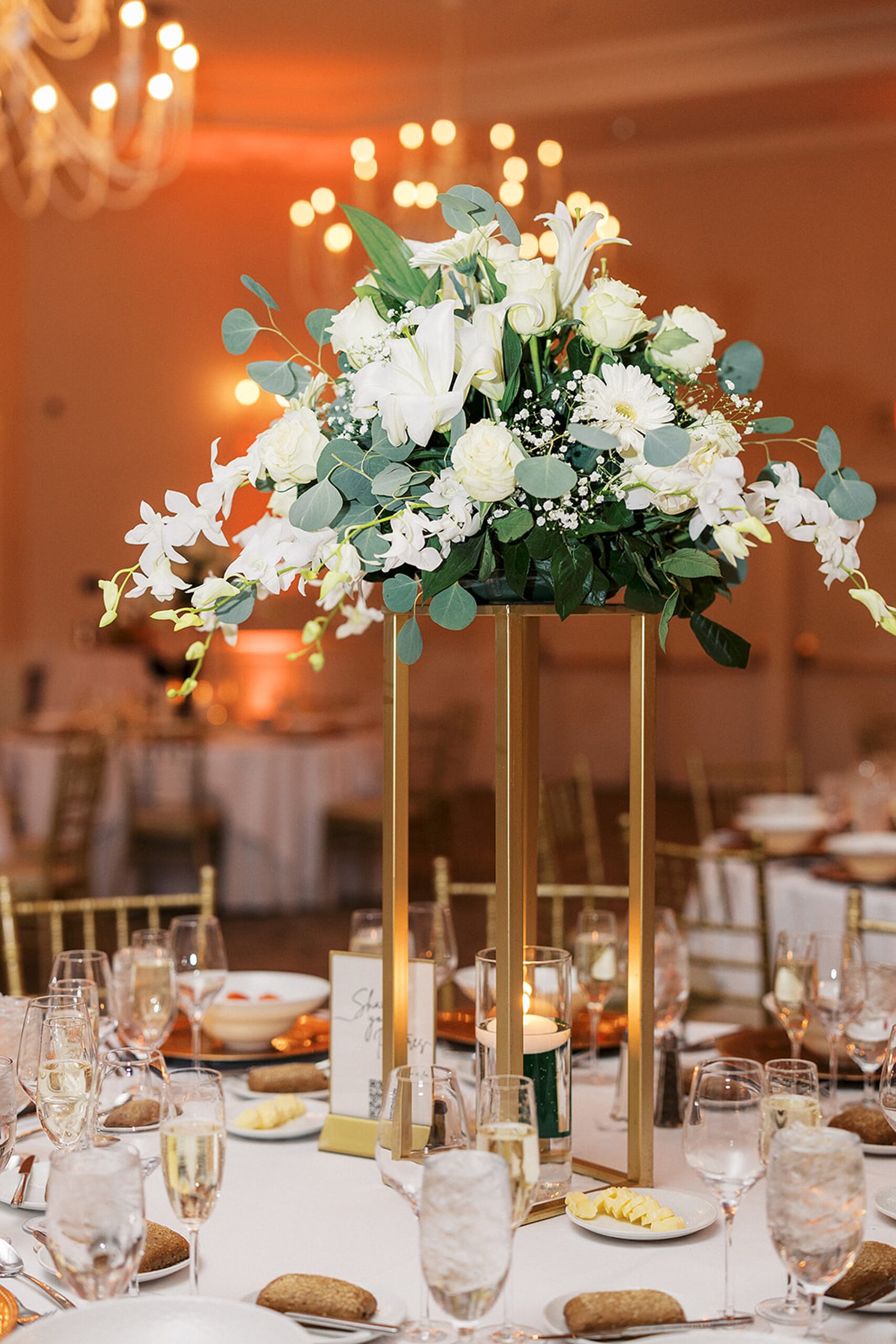 Details of a wedding reception table with white florals and linens at a Crystal Springs Wedding