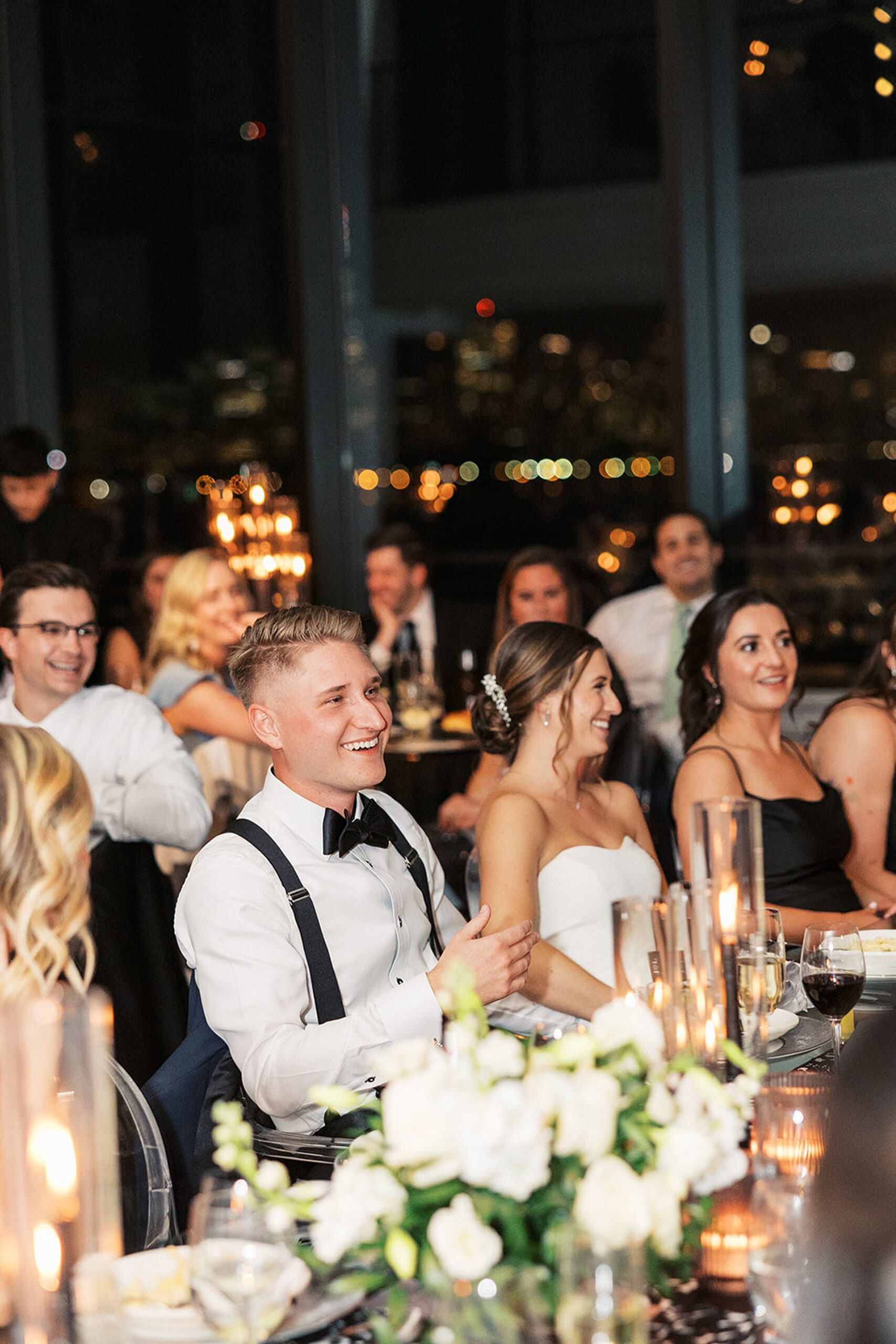 Newlyweds and friends laugh while listening to toasts Hudson House wedding