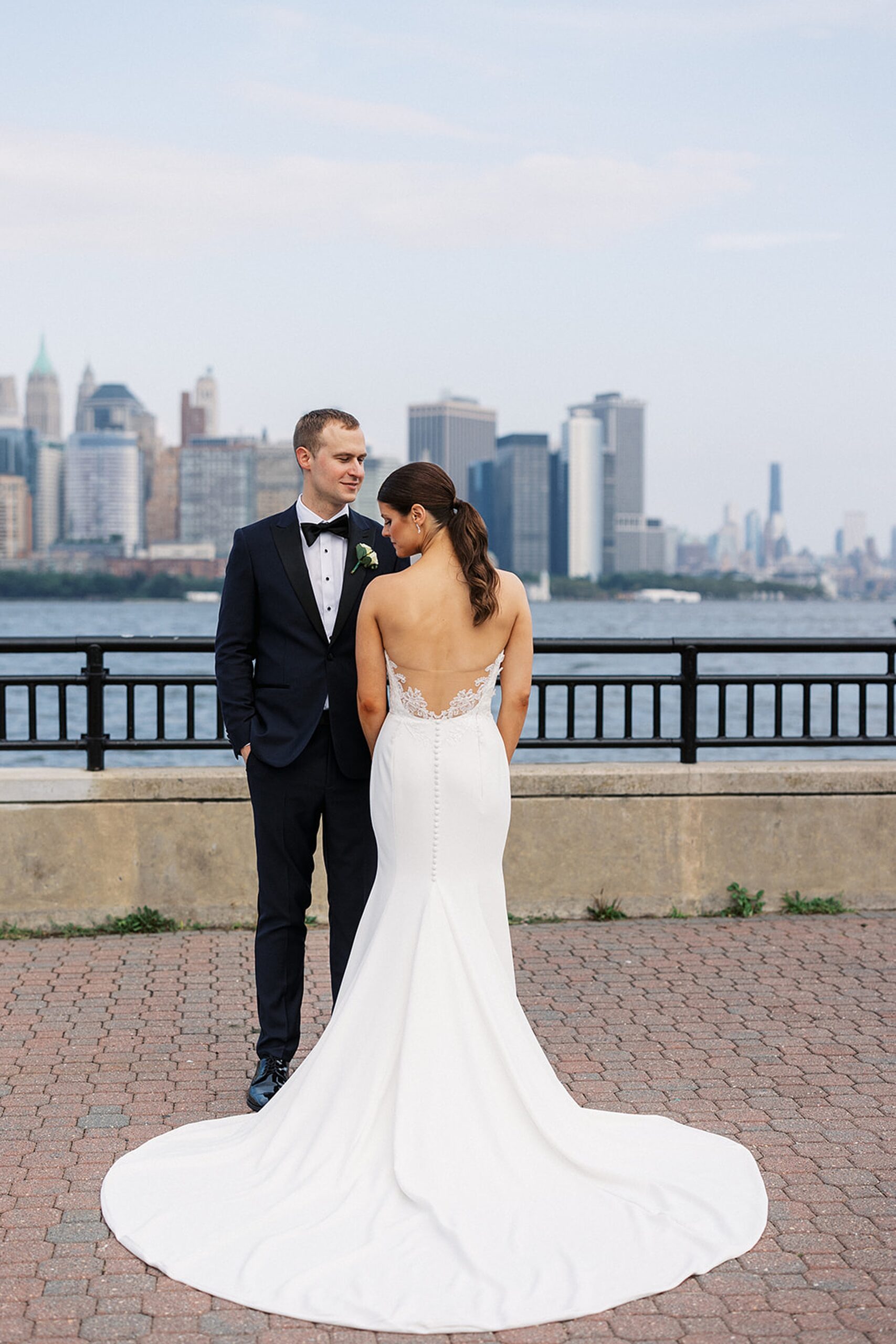 Newlyweds stand together on the river for their Liberty House Wedding