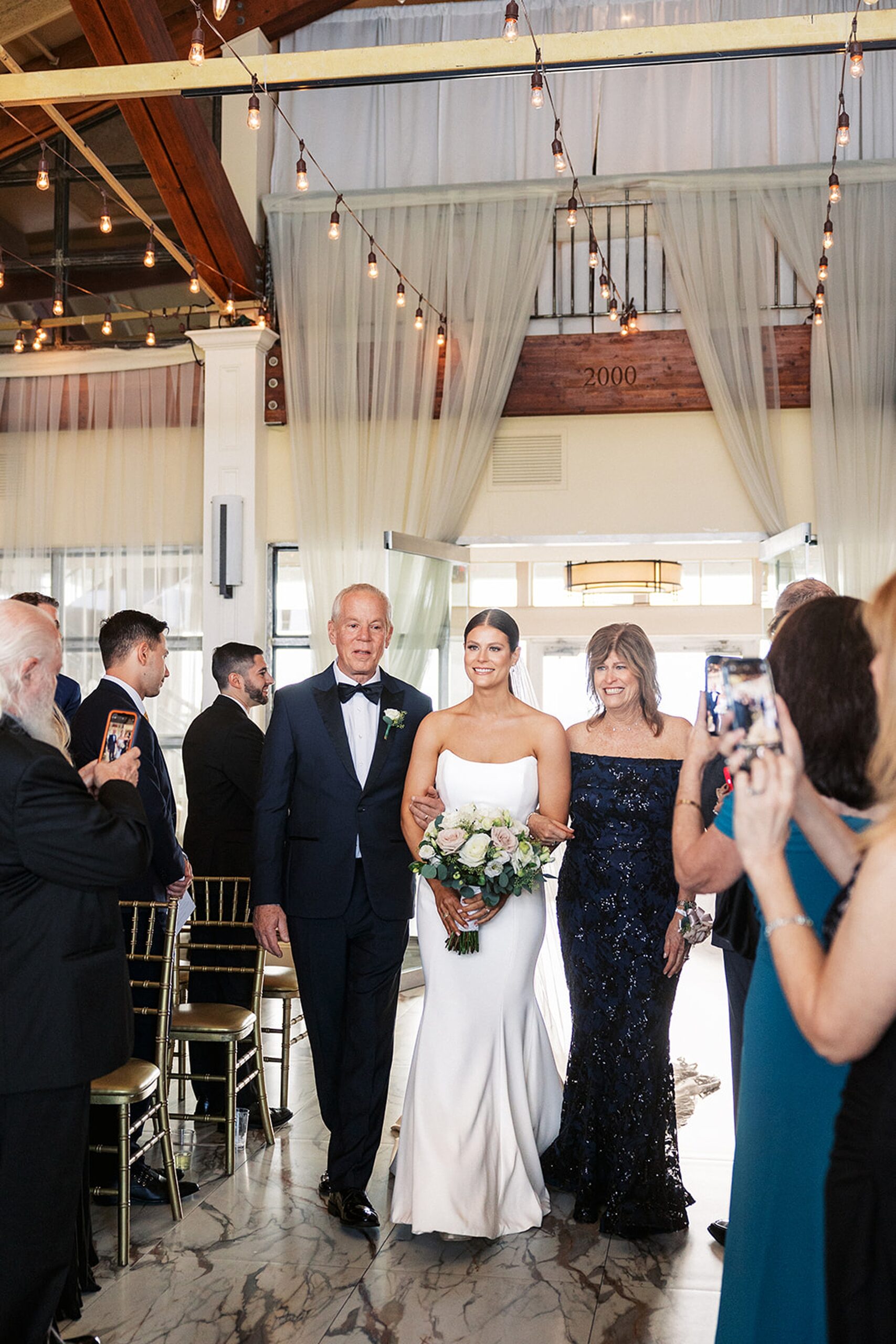 Mom and dad walk their daughter down the aisle of her Liberty House Wedding