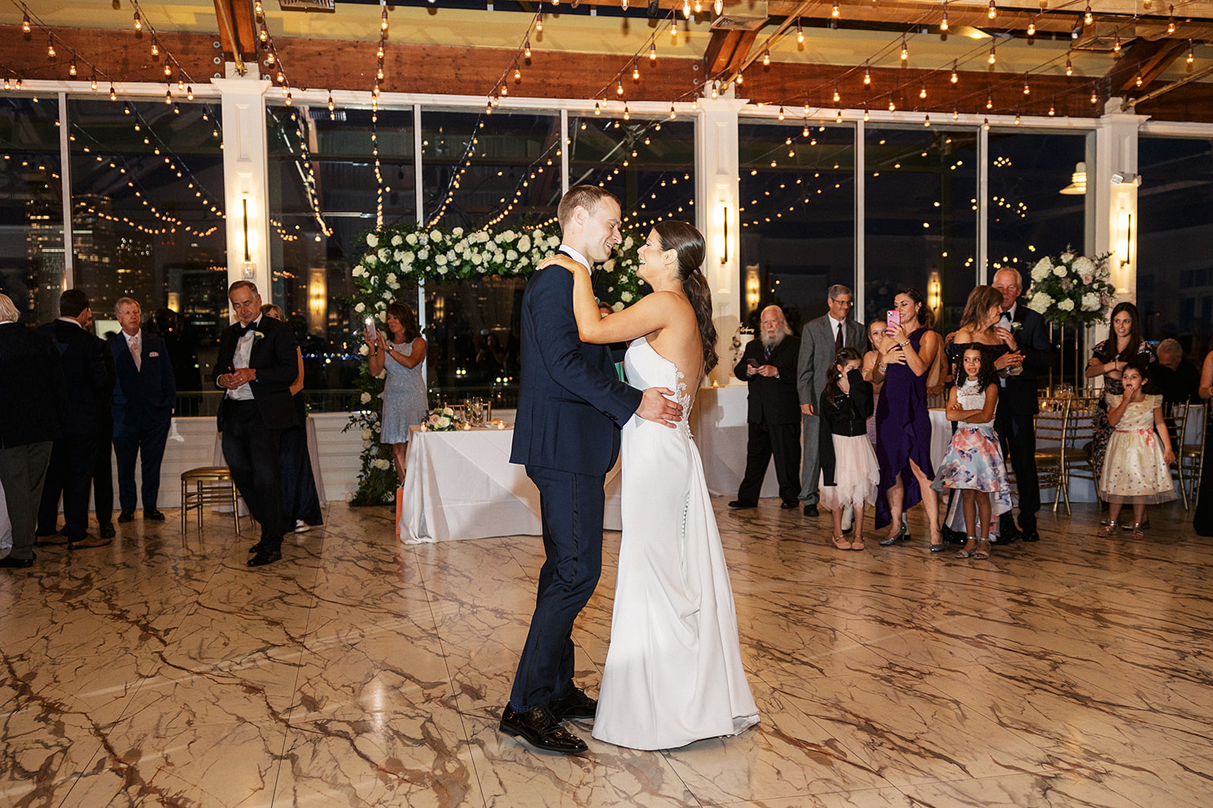 Newlyweds dance and laugh together on marble floor of the Liberty House Wedding venue