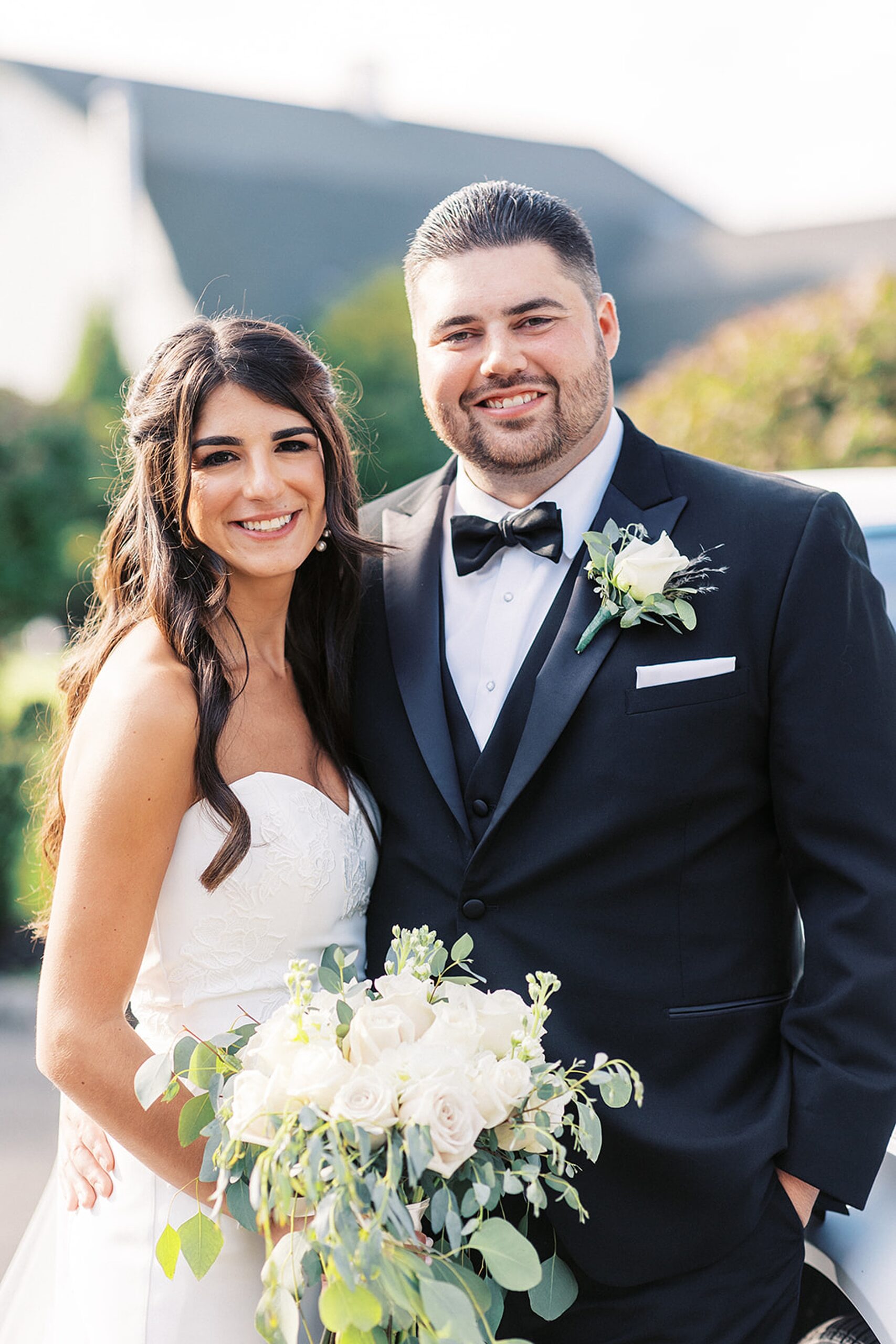 Newlyweds stand together outside their edgewood country club wedding