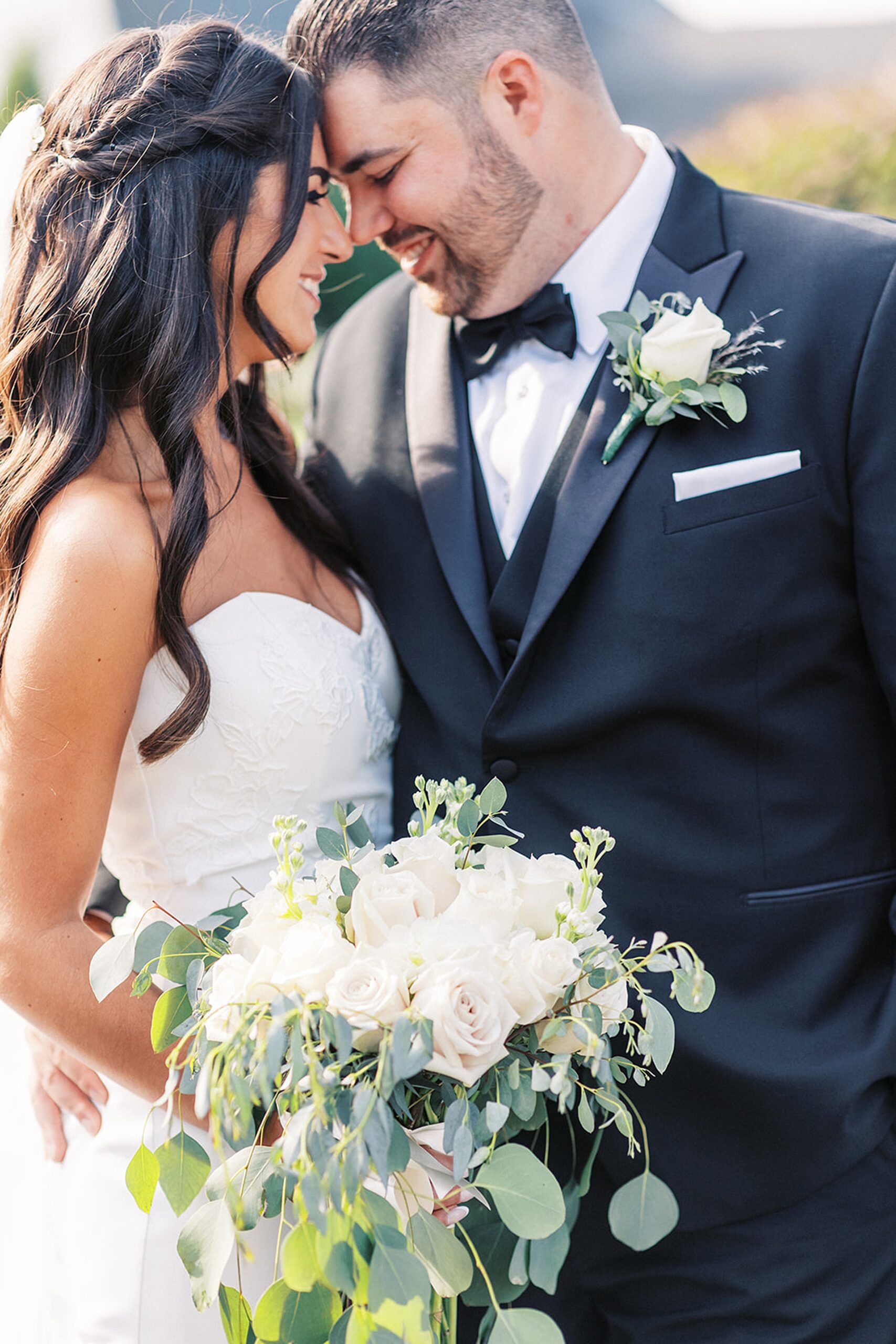 NEwlyweds embrace and touch foreheads at their edgewood country club wedding