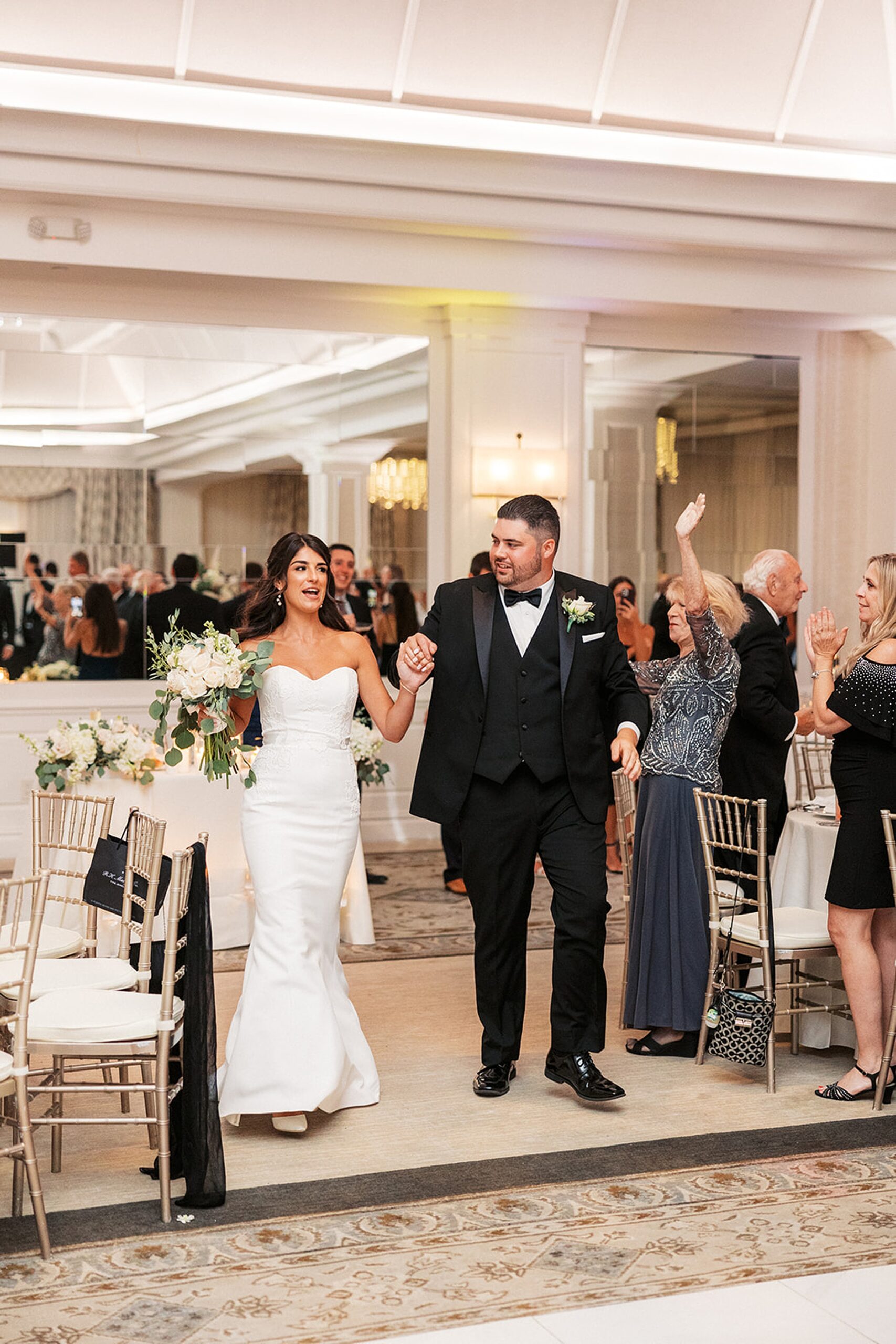Newlyweds celebrate with their guests as they enter their reception