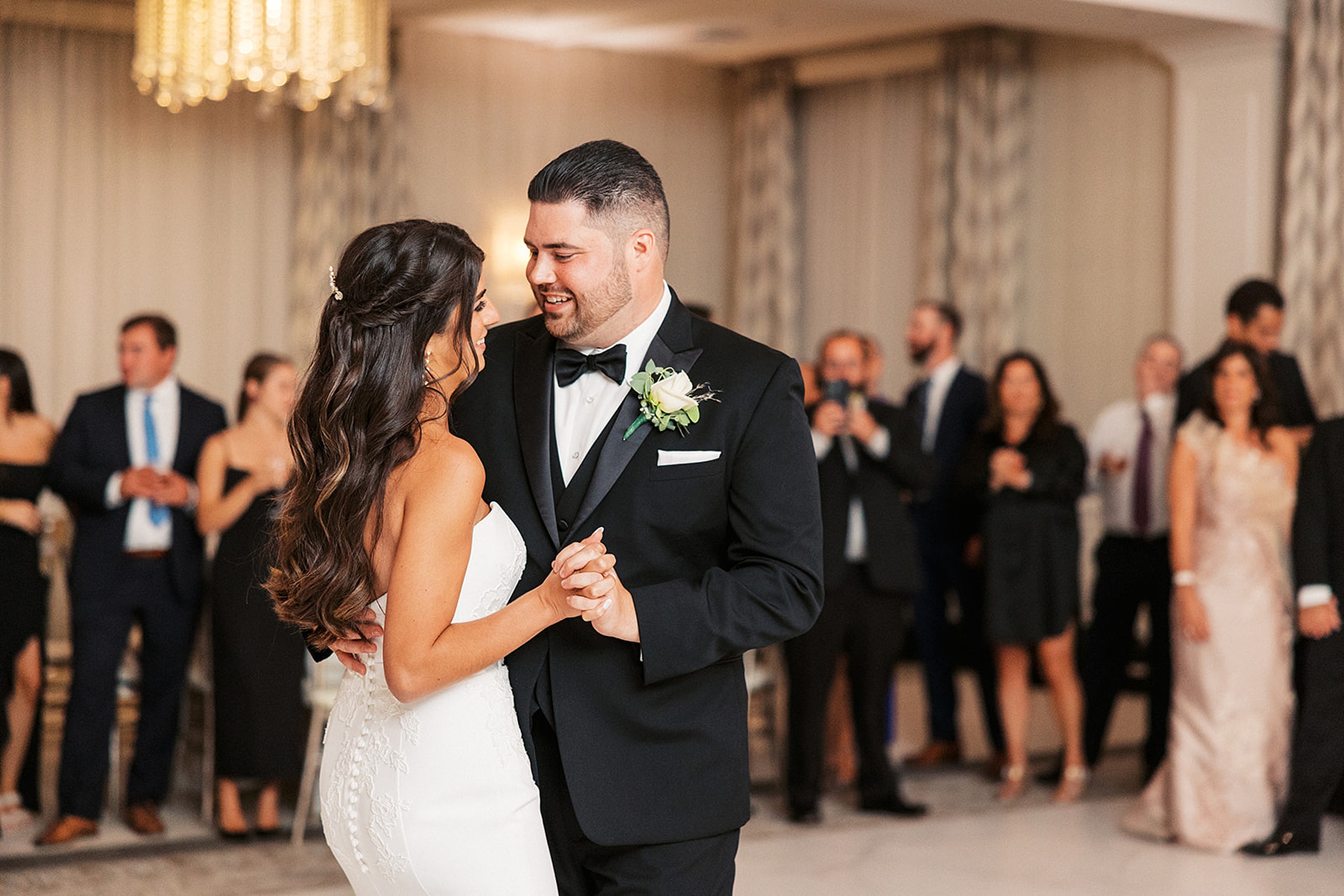 Newlyweds dance for the first time surrounded by guests at their edgewood country club wedding