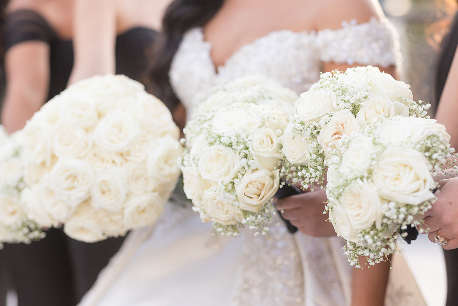 Details of a bride and her bridesmaids holding their bouquets at a Crystal Plaza Wedding