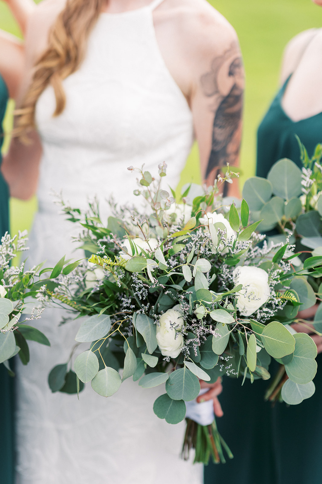 Details of a bride holding her white rose and eucalyptus bouquet at a Galloping Hill Wedding