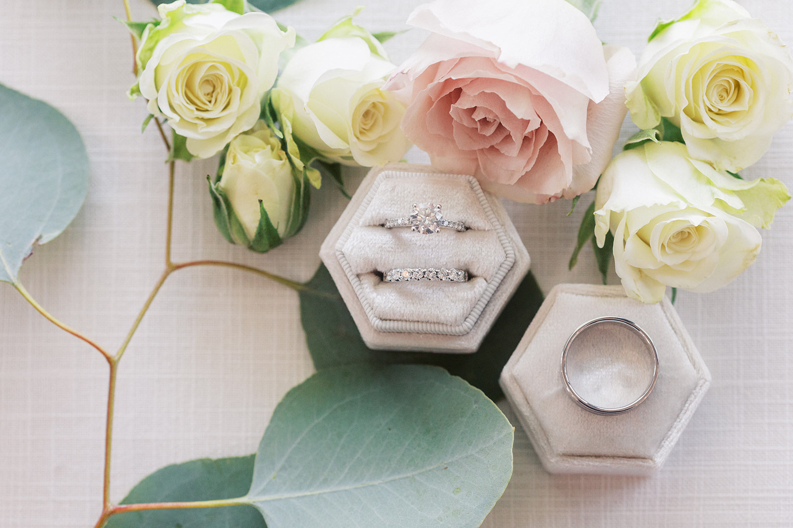 Details of wedding rings on a ring box with roses