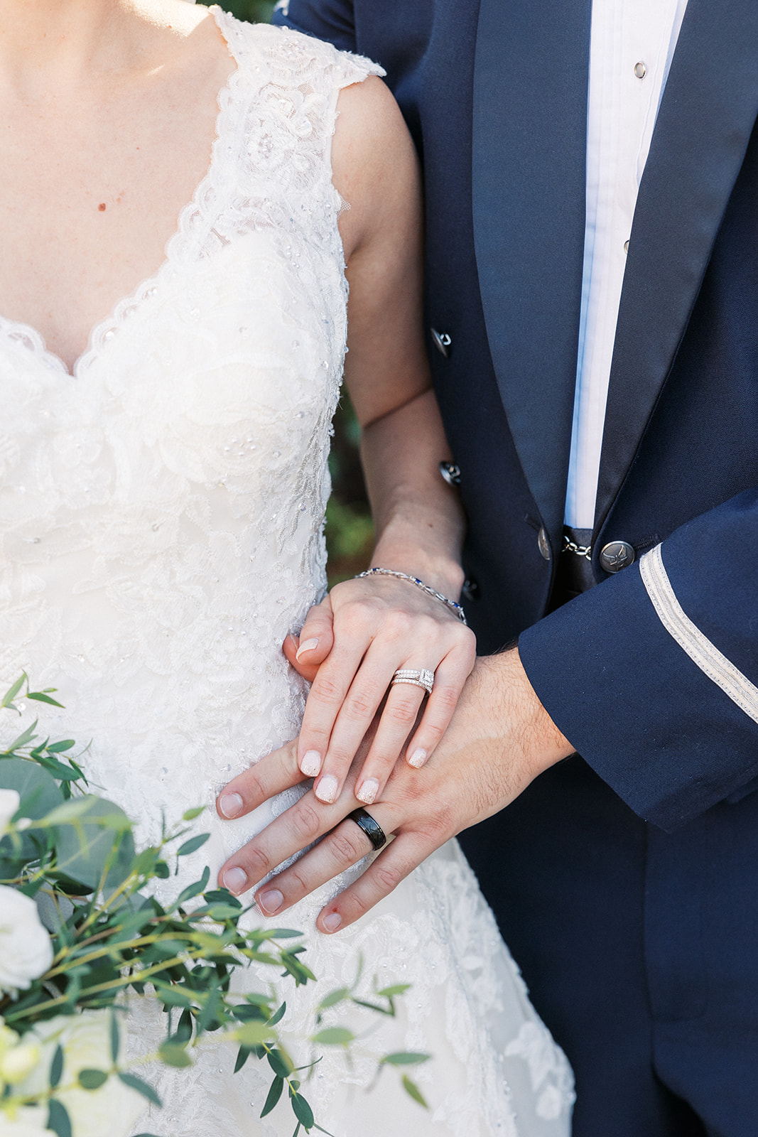 Details of newlyweds holding hands with their ring hands at The Mansion at Mountain Lakes