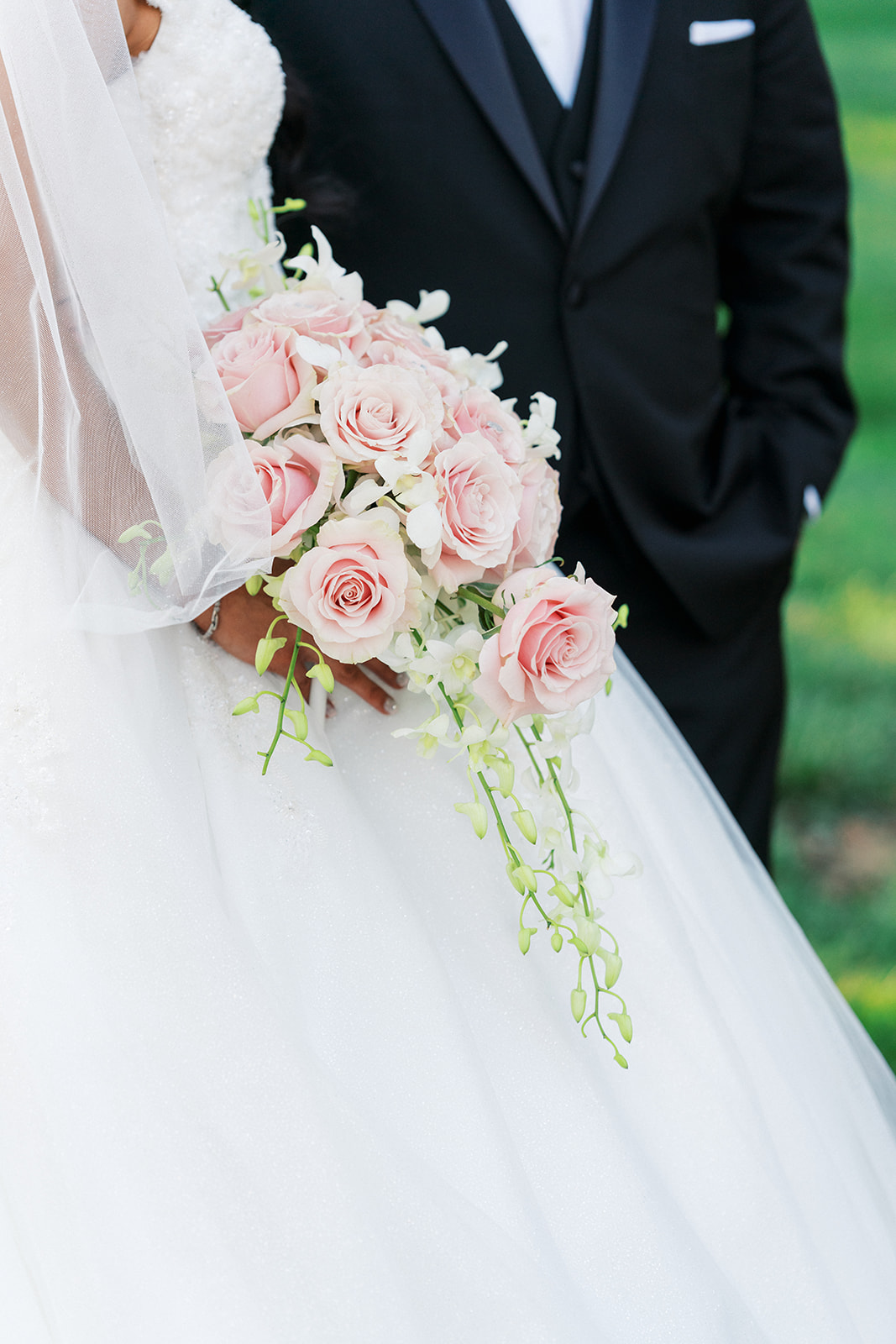 Details of a bride holding her pink rose bouquet
