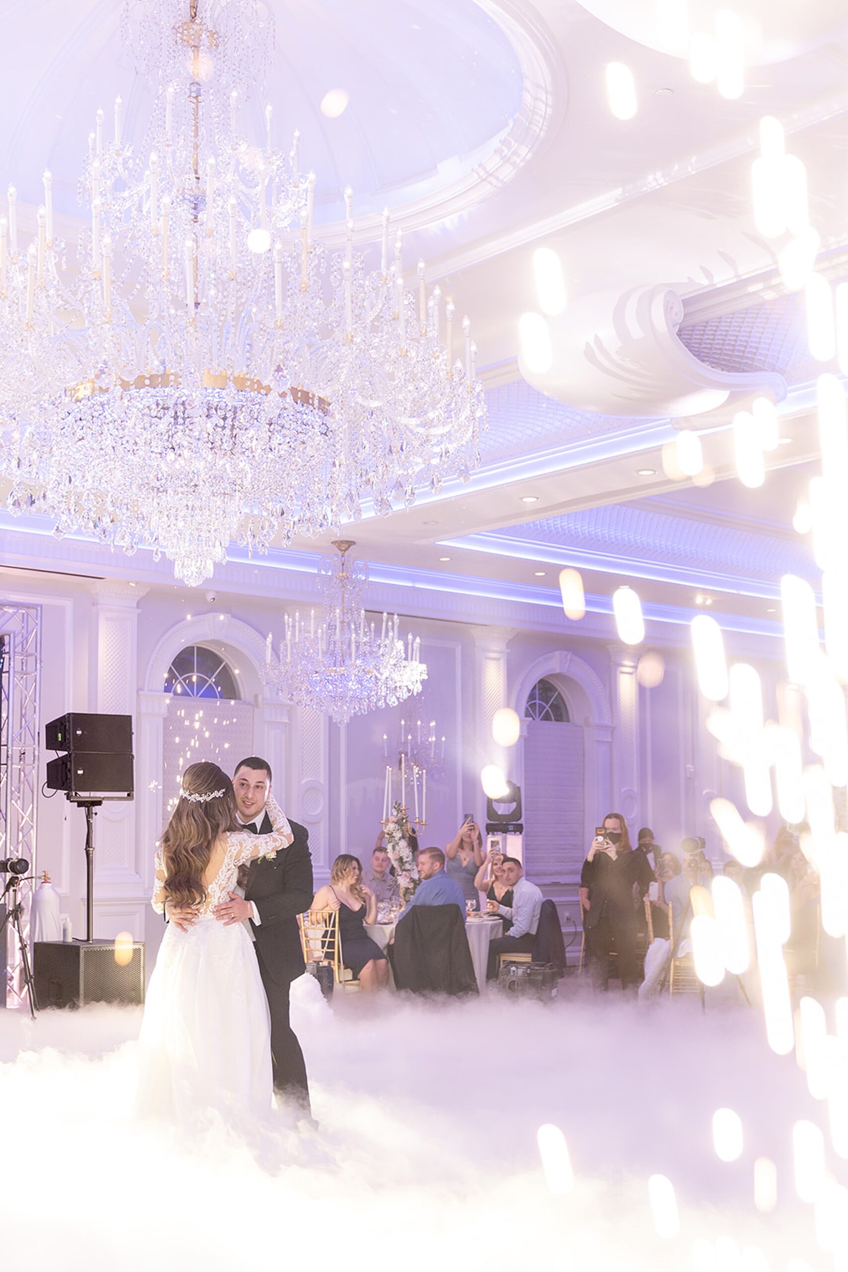 Newlyweds dance under crystal chandeliers as ground fog and fireworks go off at the rockleigh wedding venue