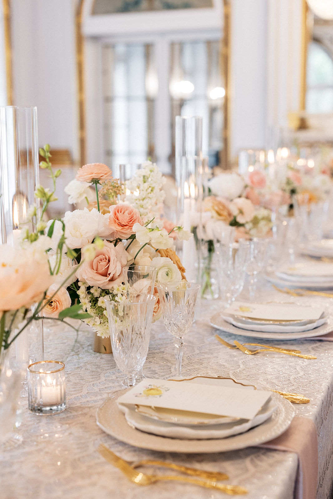 Details of a wedding reception table with pink rose centerpieces