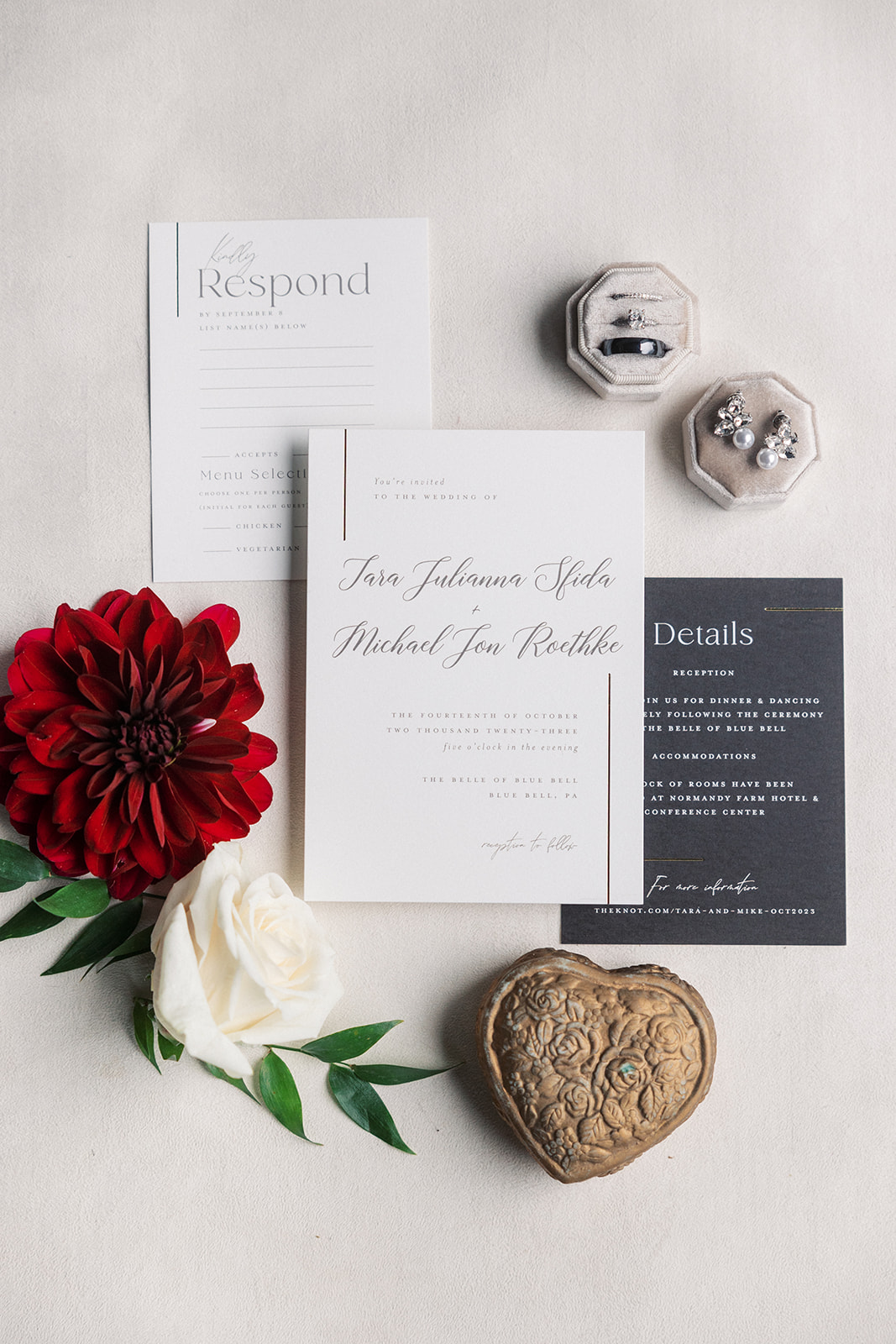 Details of wedding invitations, rings and earrings