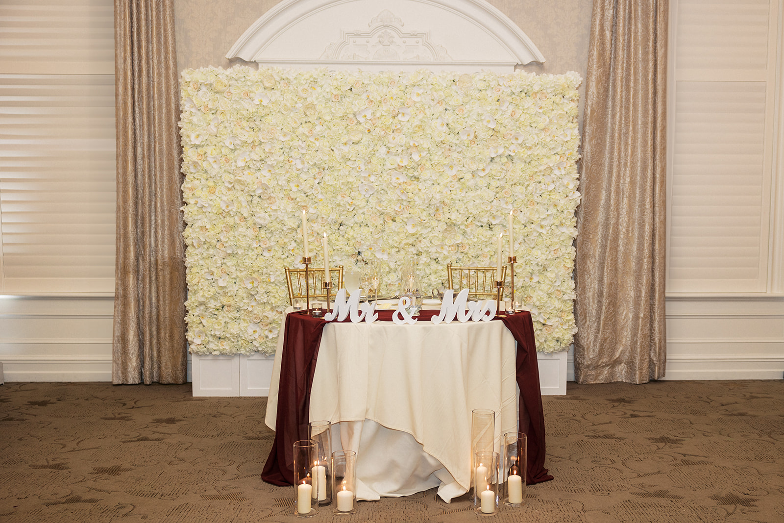 Details of a head table set up for a The Belle of Blue Bell wedding reception with a large floral wall