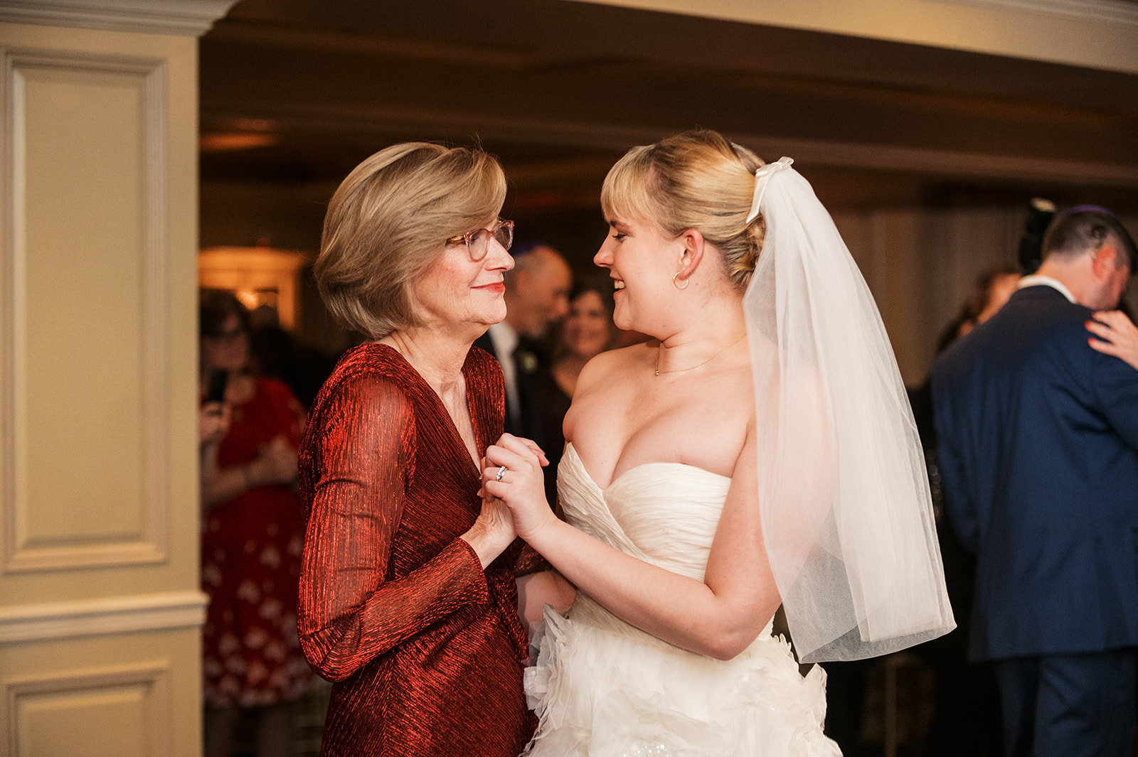 A bride dances with mom at her Olde Mill Inn Wedding reception