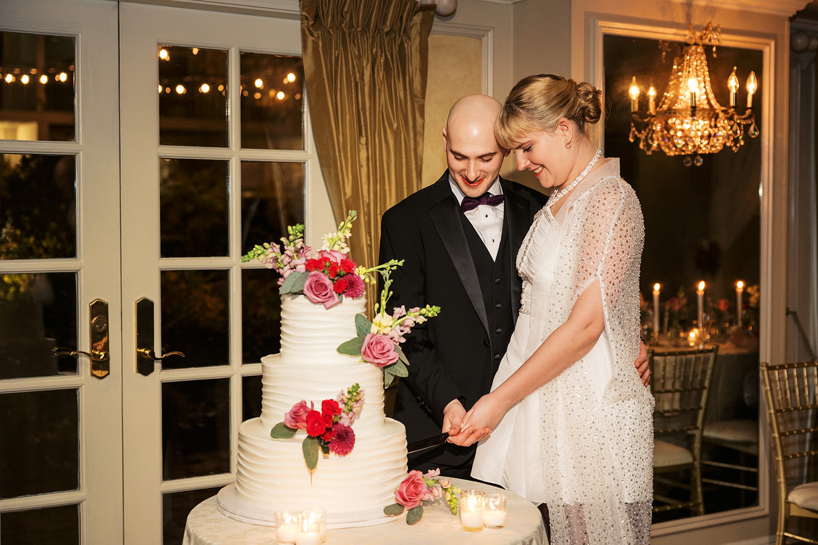Newlyweds cut their three tier cake Olde Mill Inn Wedding