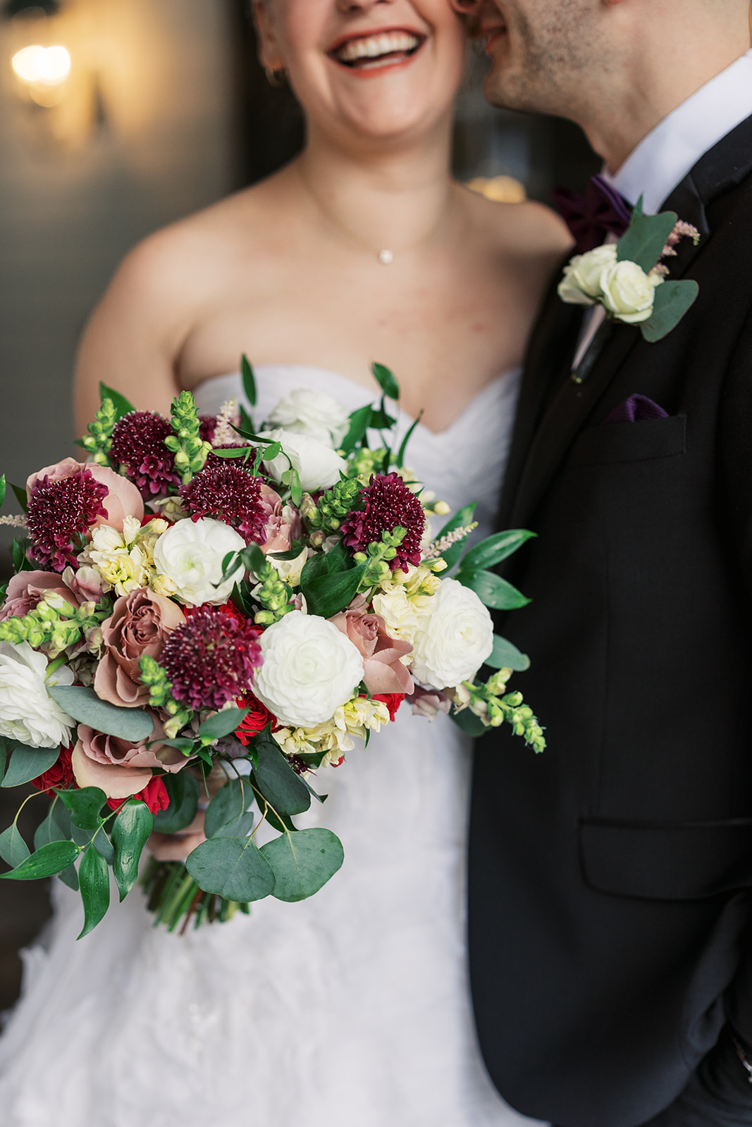 Details of a bridal bouquet with purple, pink and white flowers