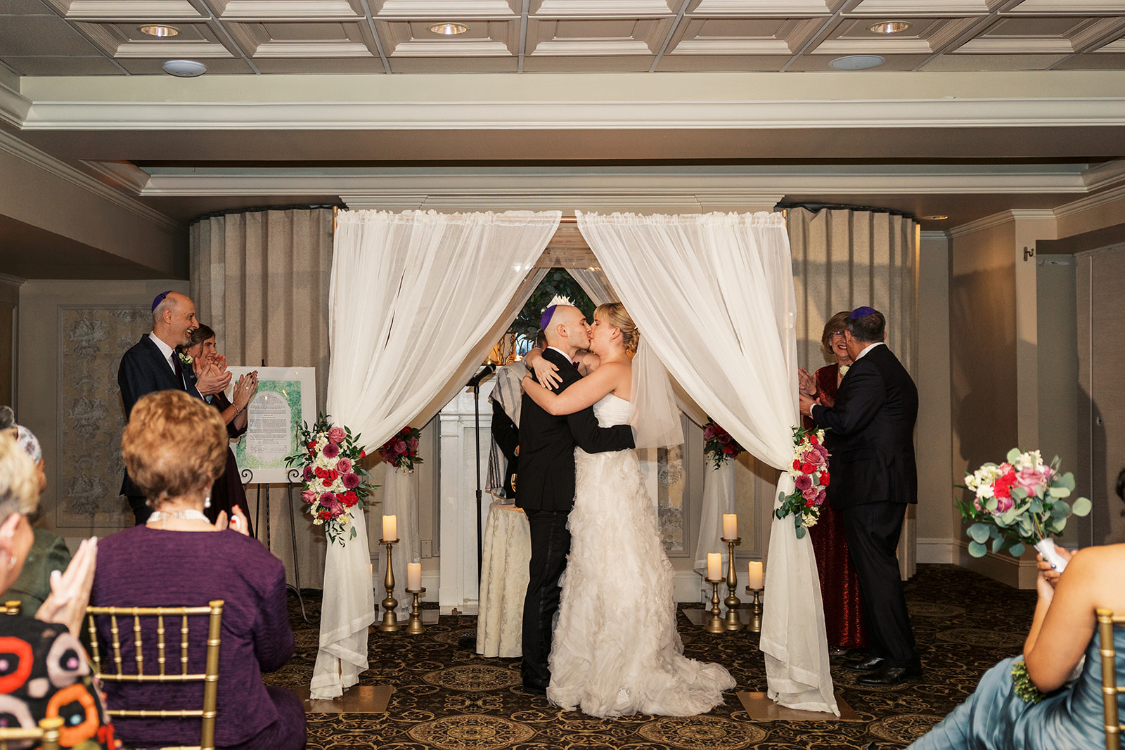 Newlyweds kiss at the altar to applause at the end of their ceremony