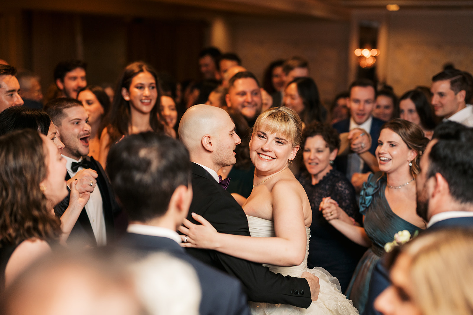 Newlyweds dance on the dance floor with all of their guests