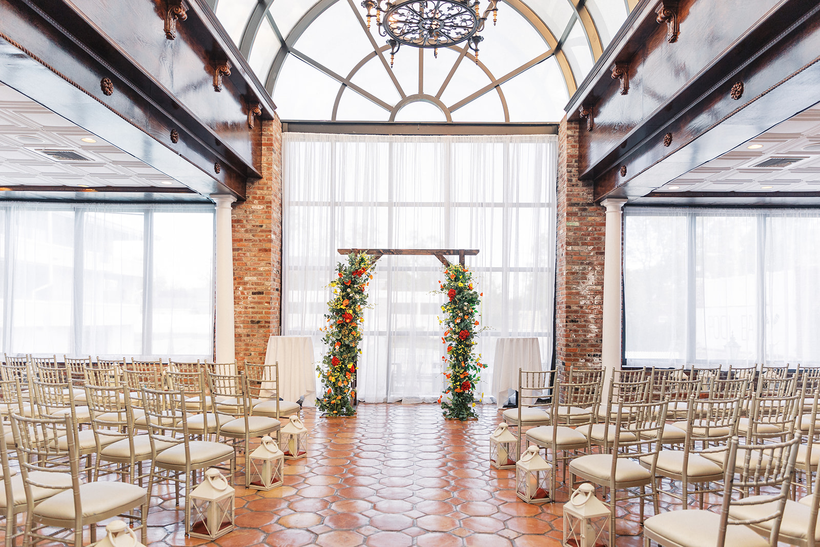 Details of a wedding ceremony set up with gold chairs and a flower covered arbor at The Shore Club Boutique Hotel