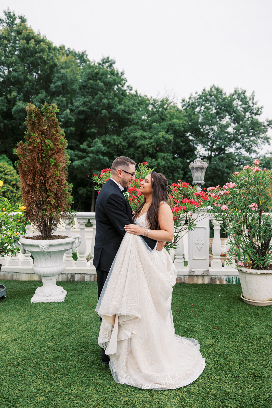 Newlyweds share a close intimate moment on a garden terrace Villa Barone Hilltop Manor