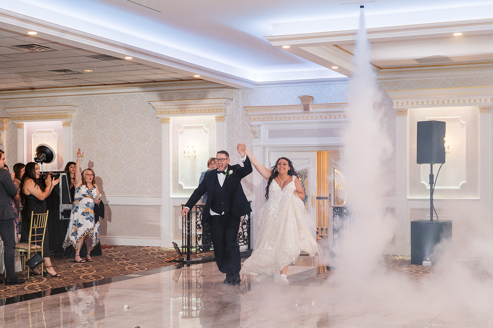 Newlyweds enter their wedding reception to cheer and a smoke machine at Villa Barone Hilltop Manor