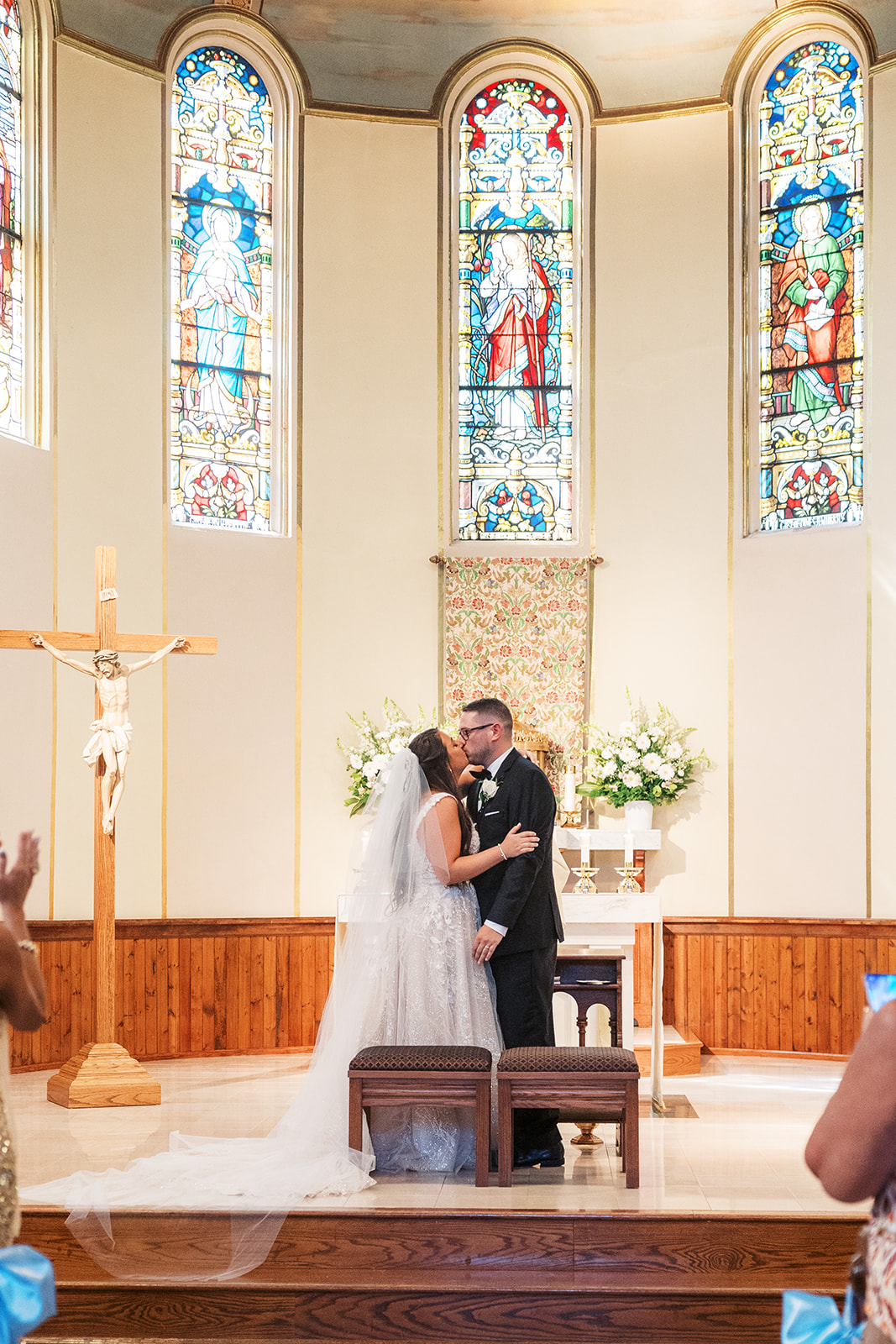 Newlyweds kiss at the church altar during their ceremony