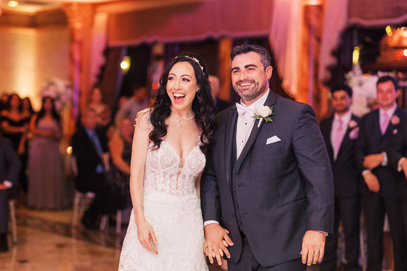 Newlyweds smile big while entering their Seasons Catering Wedding ceremony