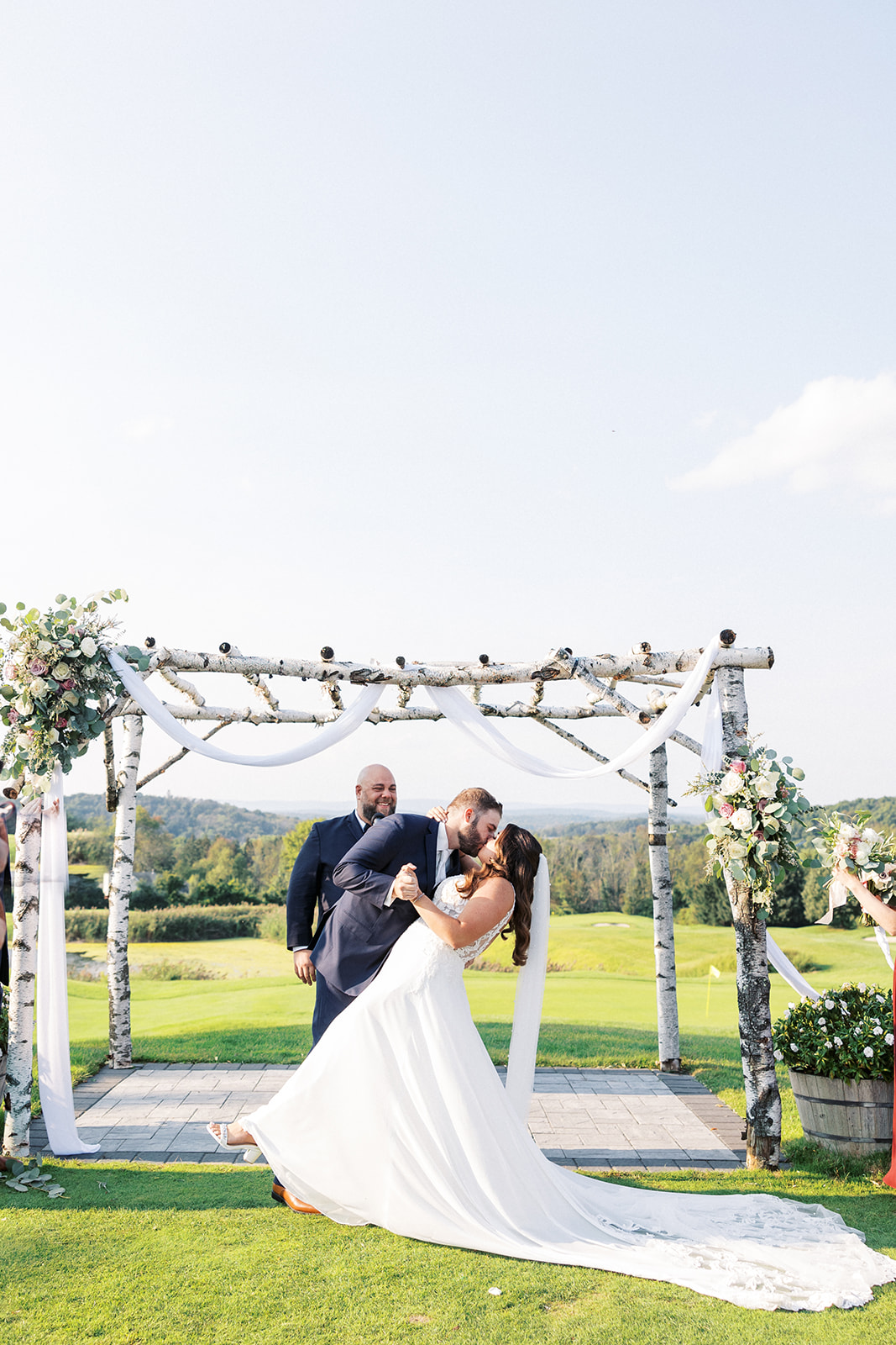 Newlyweds kiss at the altar under an aspen arbor to end their Skyview Golf Club Wedding ceremony