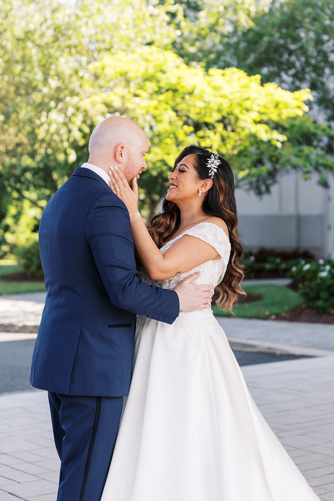 Newlyweds dance together while in a garden