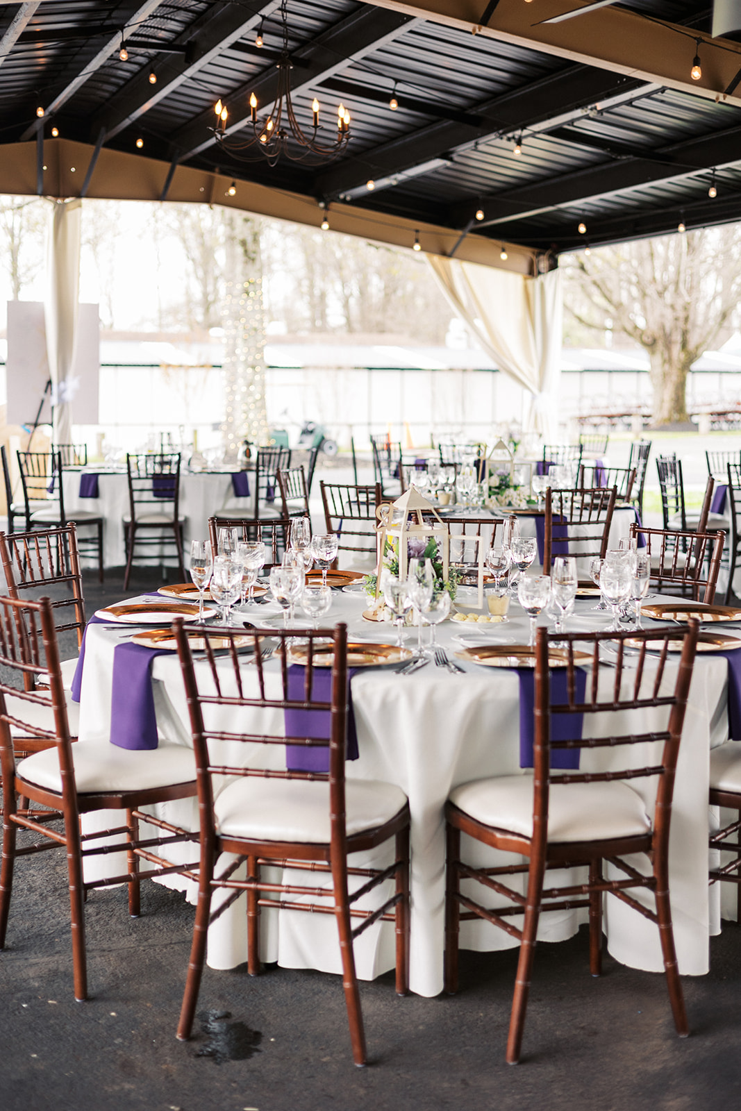Details of a Forest Lodge Wedding reception set wit white linen and purple napkins