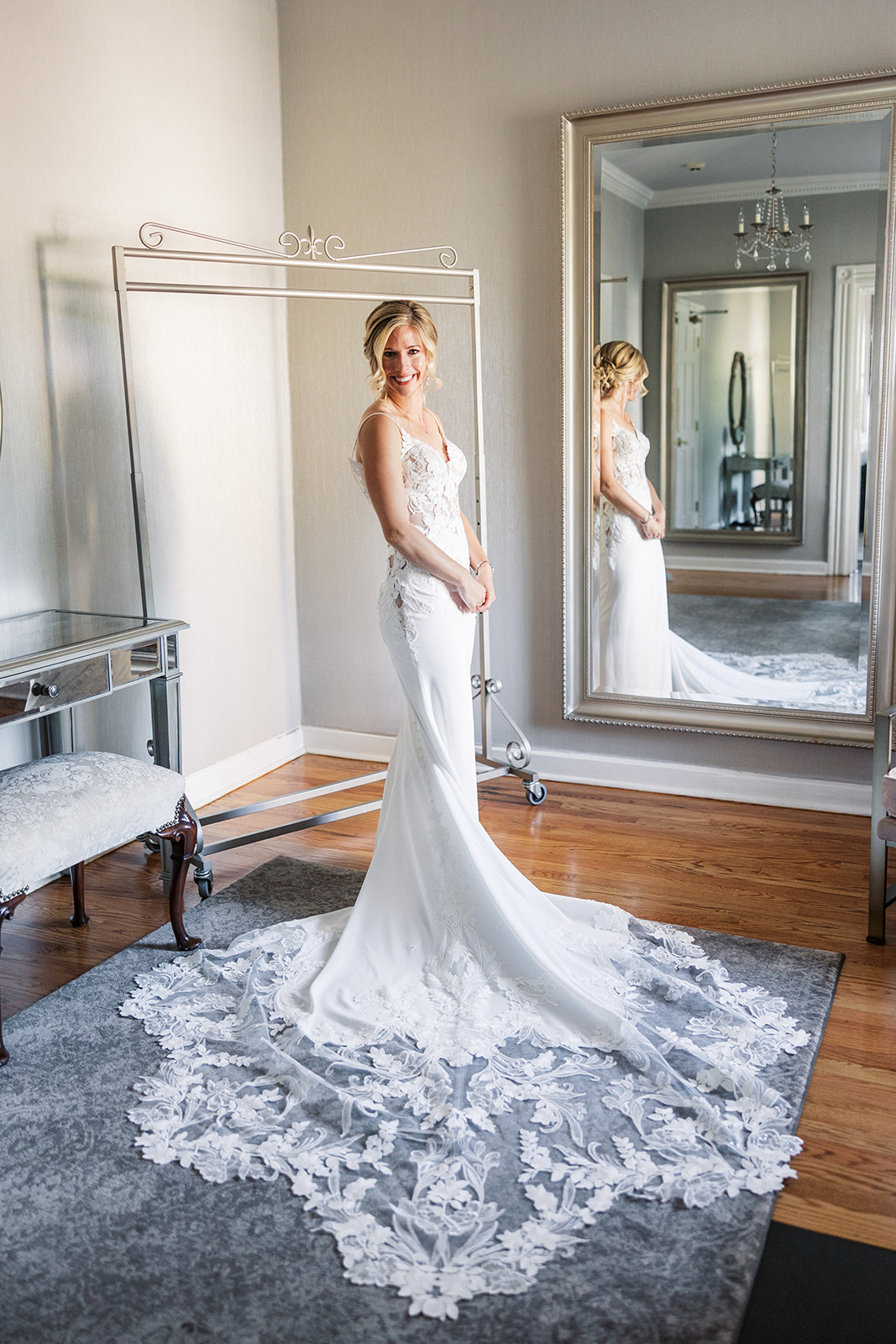 A bride stands in a mirror getting ready at the Pen Ryn Estate Wedding venue