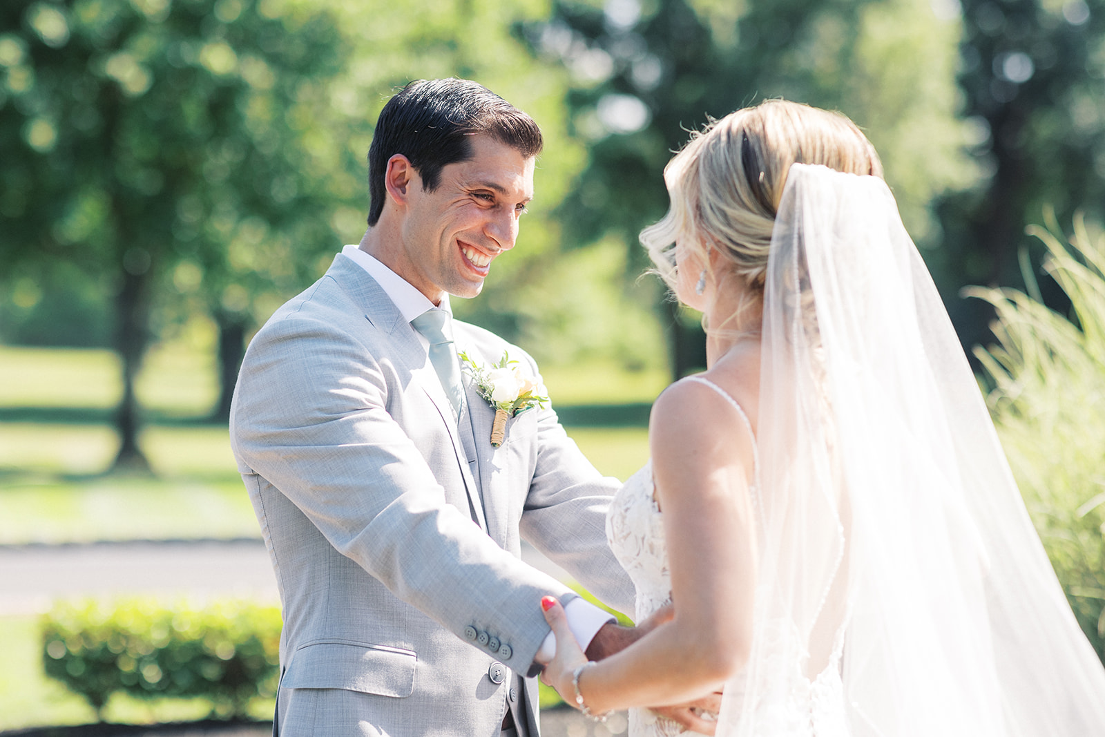 Newlyweds share a happy moment while standing in a garden