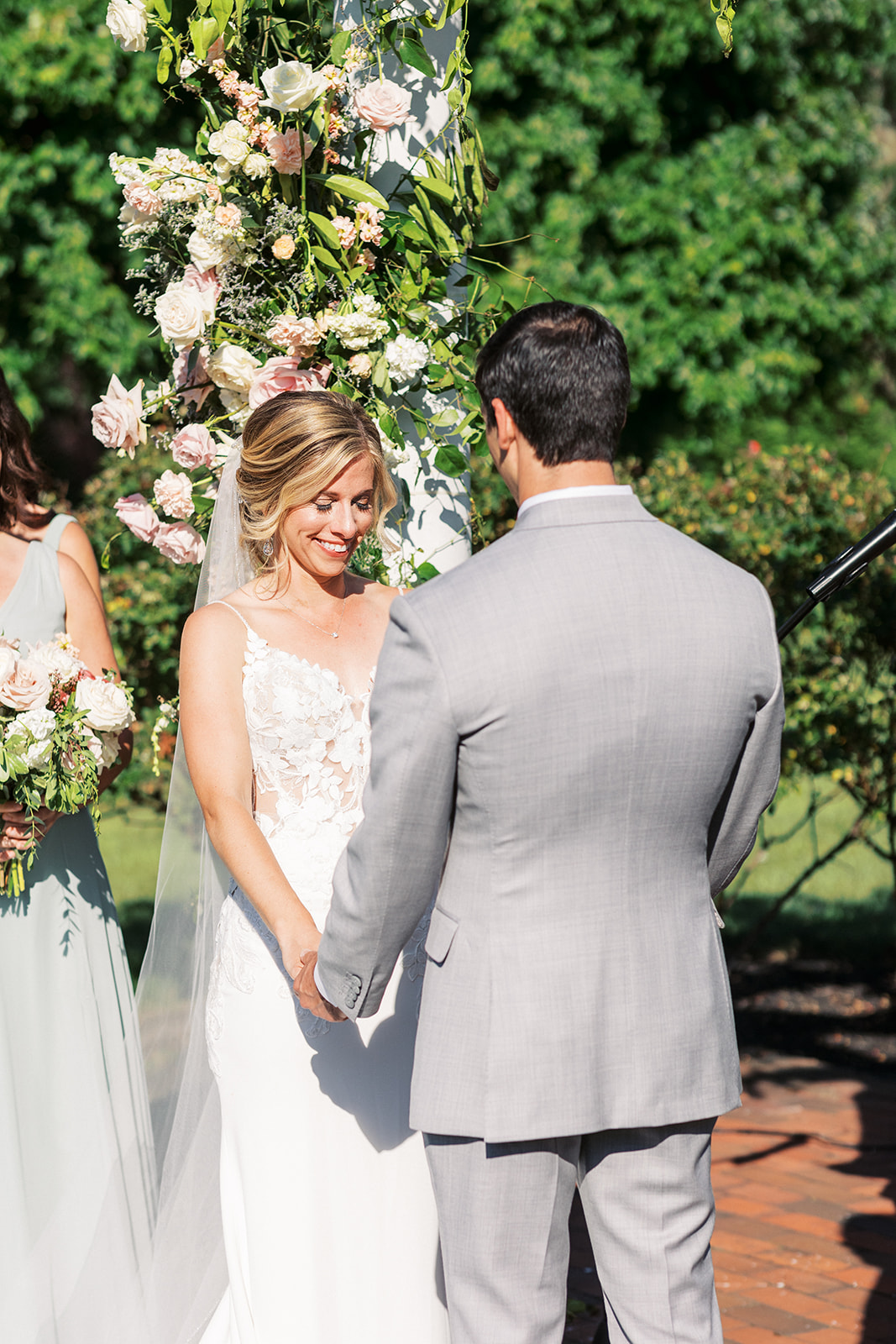 Newlyweds hold hands at the altar and smile during their Pen Ryn Estate Wedding ceremony