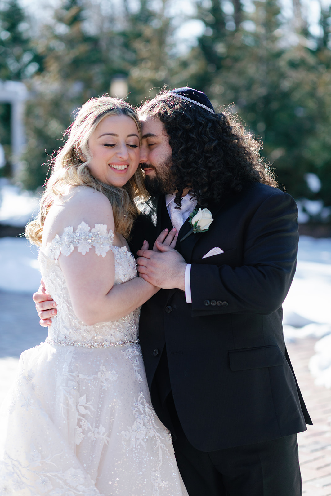 Newlyweds dance close and share a quiet moment outside in the snow