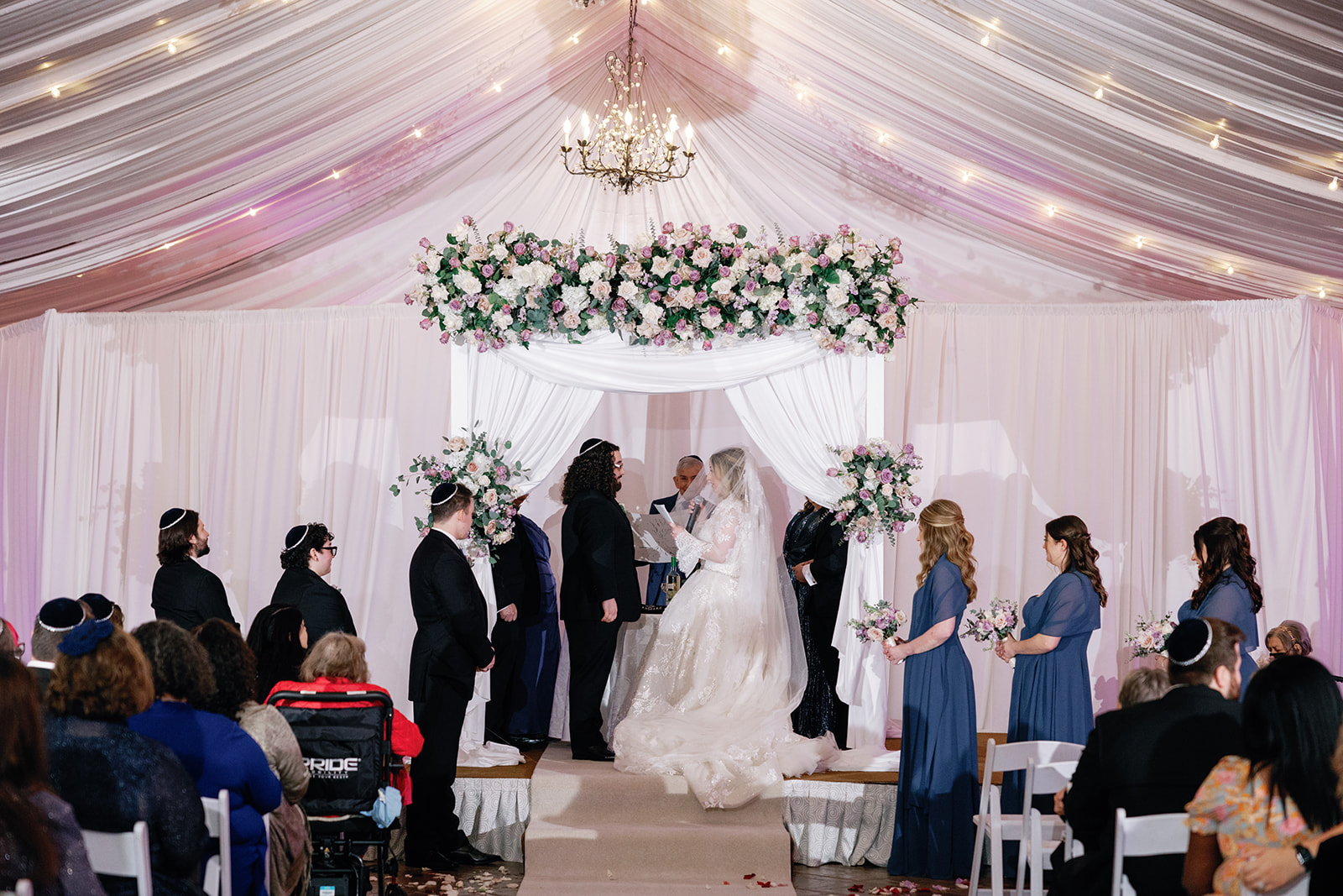 Newlyweds stand at the altar under flowers and drapes at their Crest Hollow Country Club Wedding