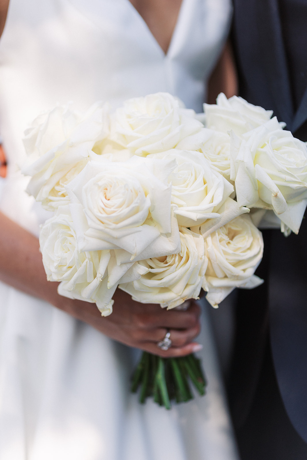 Details of a brides white rose bouquet in her hand