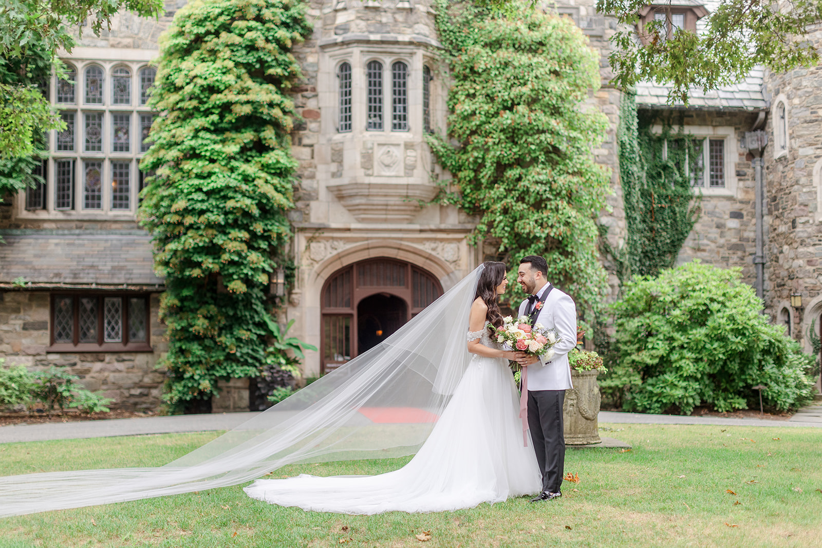 Newlyweds stand on the lawn in front of one of the New Jersey Garden Wedding Venues