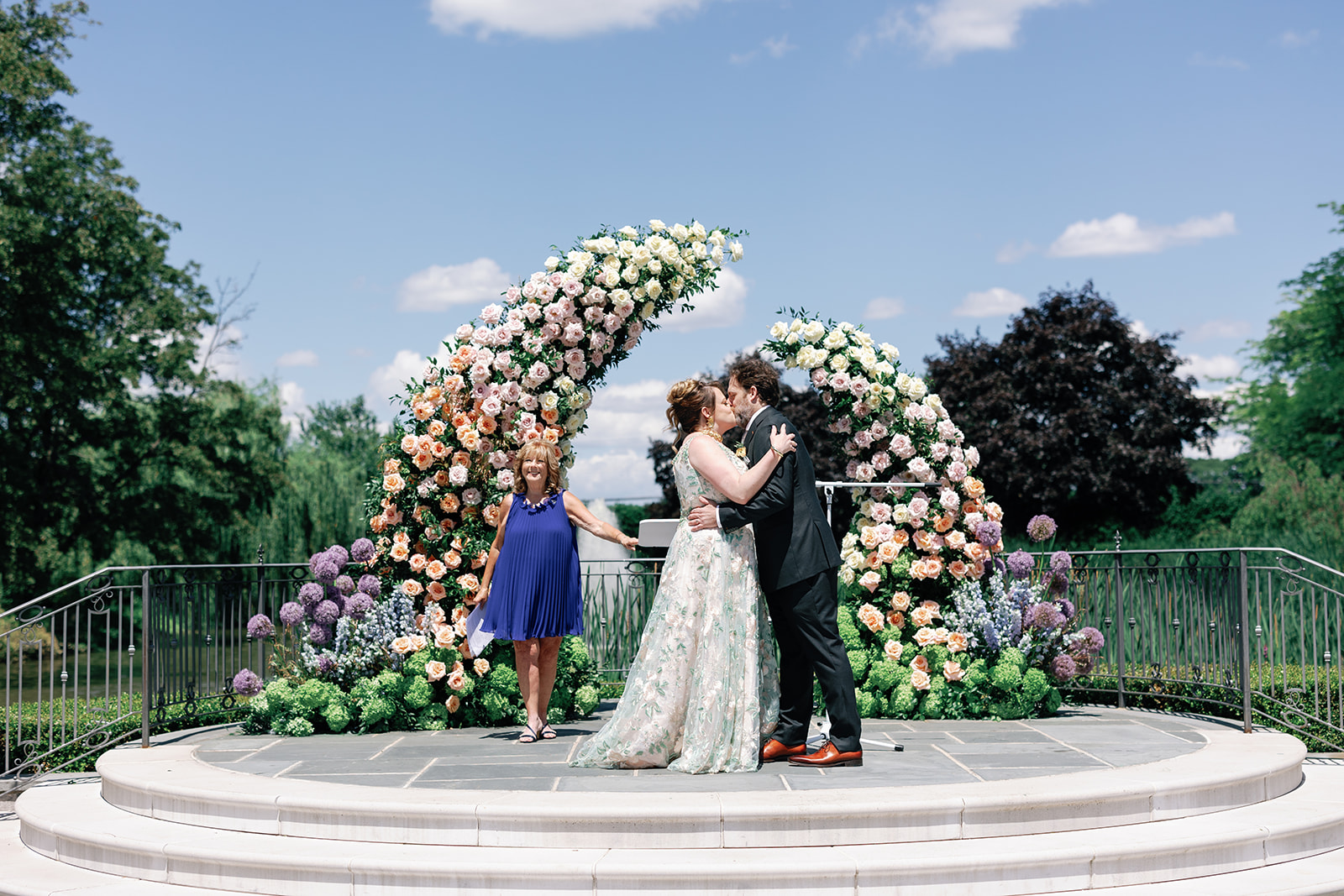 Newlyweds kiss in the gardens at their Park Chateau Wedding ceremony