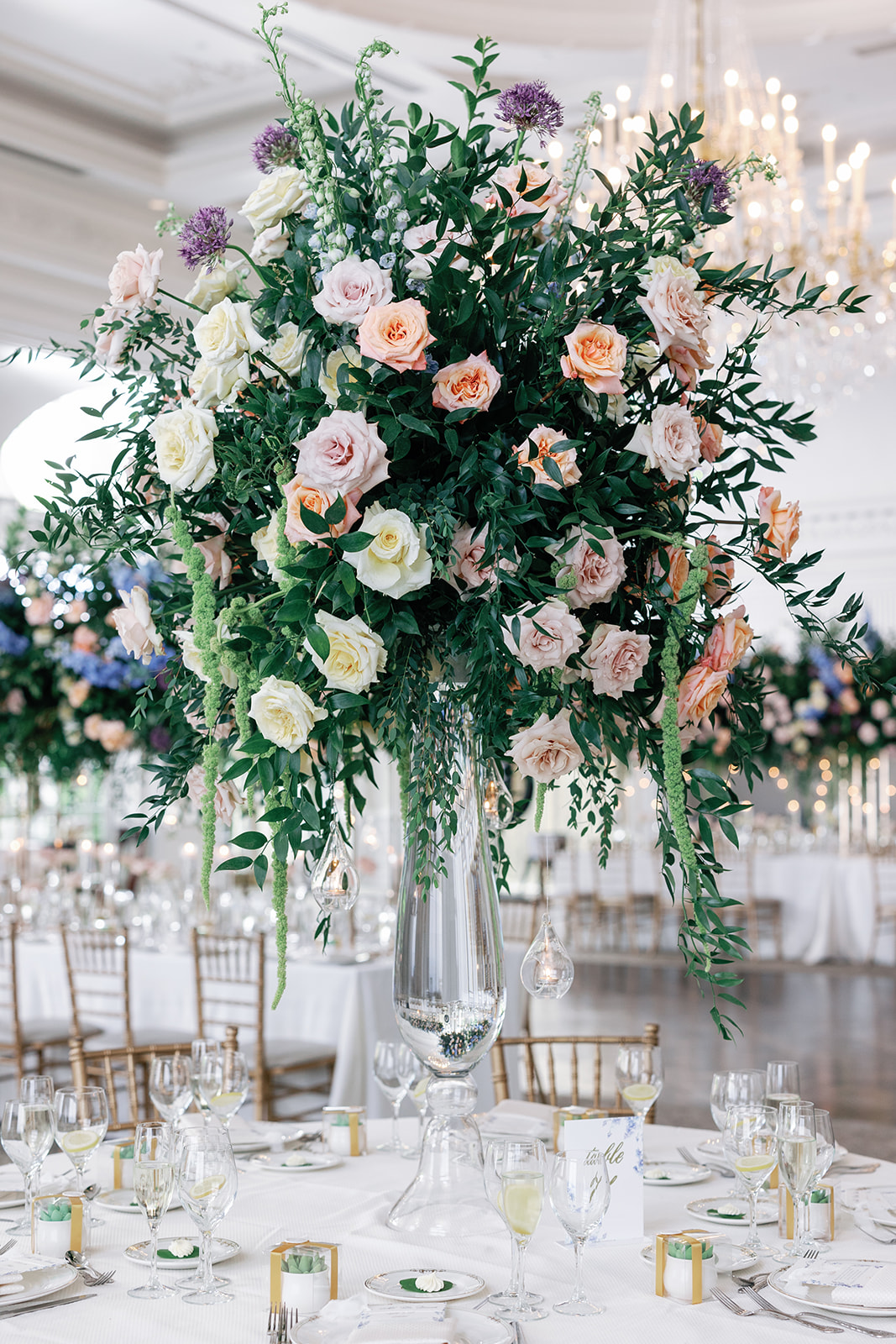 Details of a tall Park Chateau Wedding reception table center piece with colorful roses