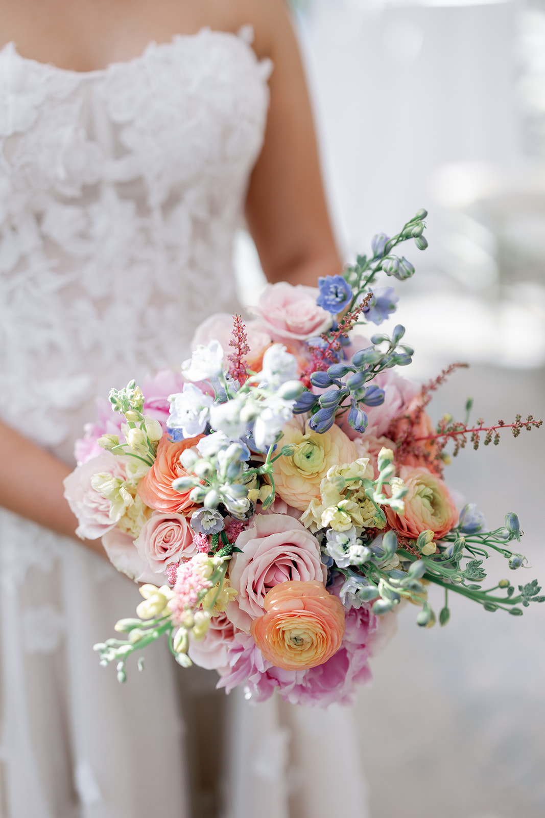 Details of a bride's colorful bouquet in her hands at The Grove Wedding Venue